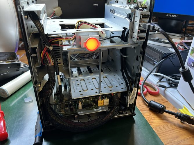 Stripped-down HP MicroServer showing a red LED (critical error)